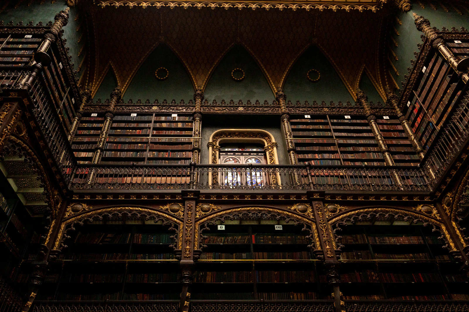Biblioteca clássica com estantes ornamentadas e livros.