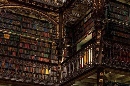 Ornate library interior with tall bookshelves filled with books.