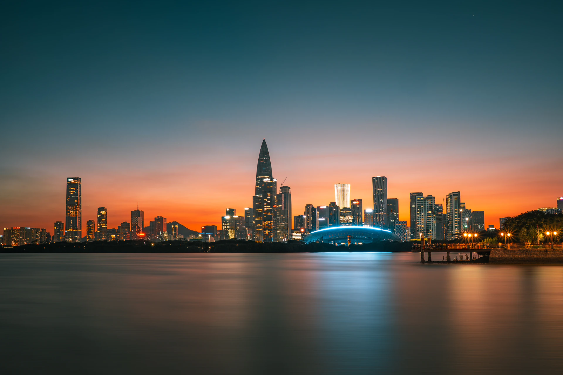 City skyline illuminated at dusk with vibrant sunset colors