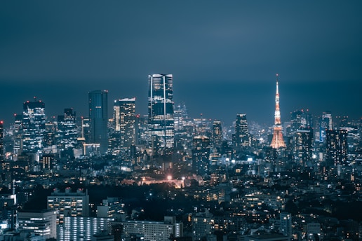 Vibrant cityscape at night with illuminated skyscrapers.