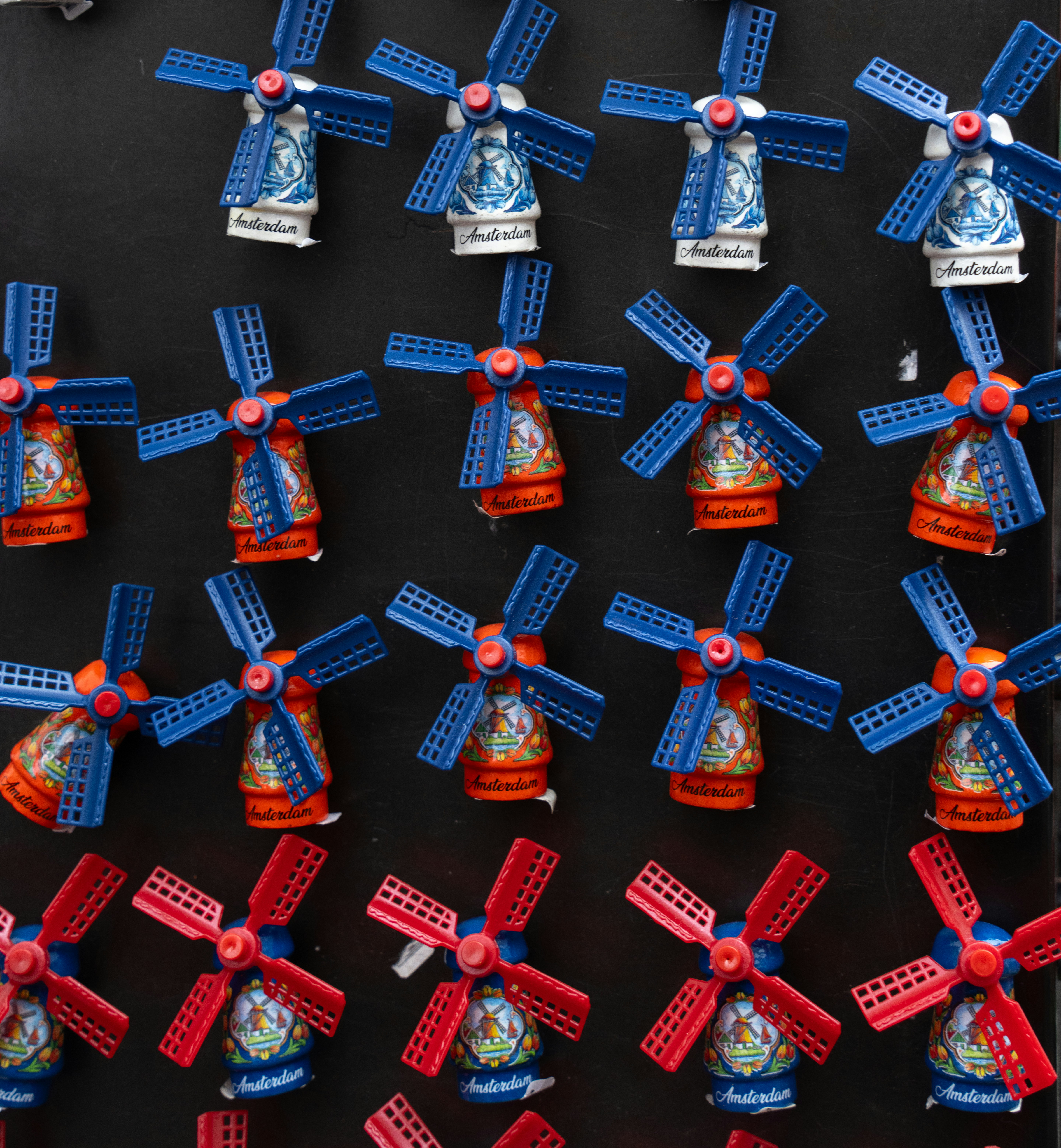 Many colorful windmill souvenirs arranged in rows