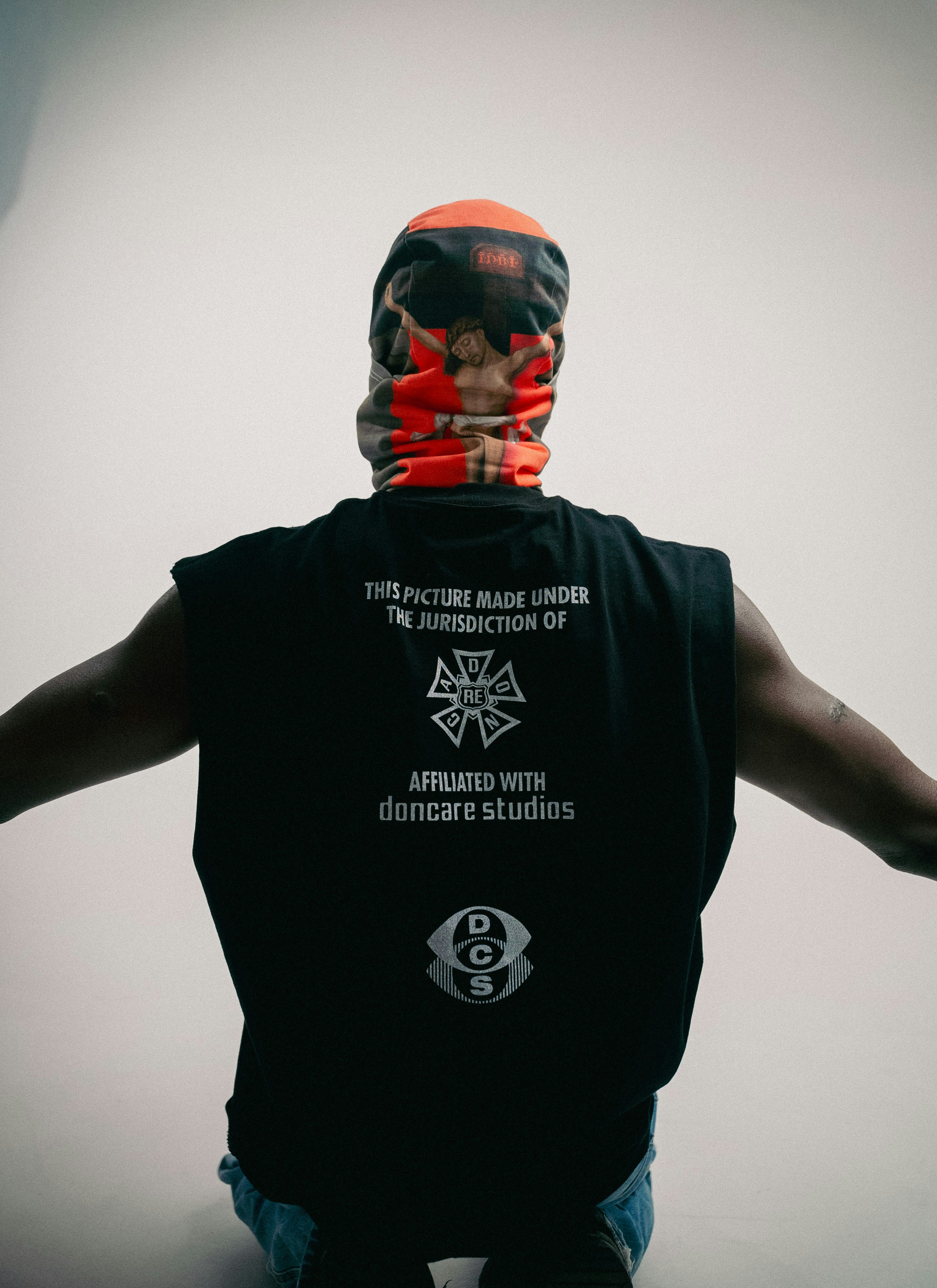 Man wearing a graphic t-shirt and face covering