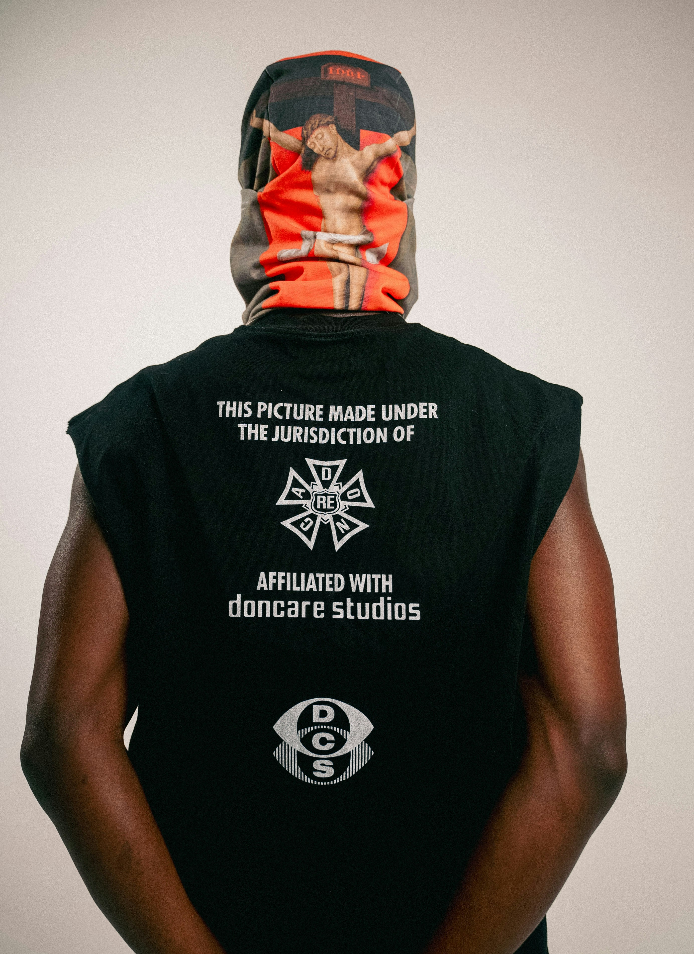 Person wearing a t-shirt with religious imagery.