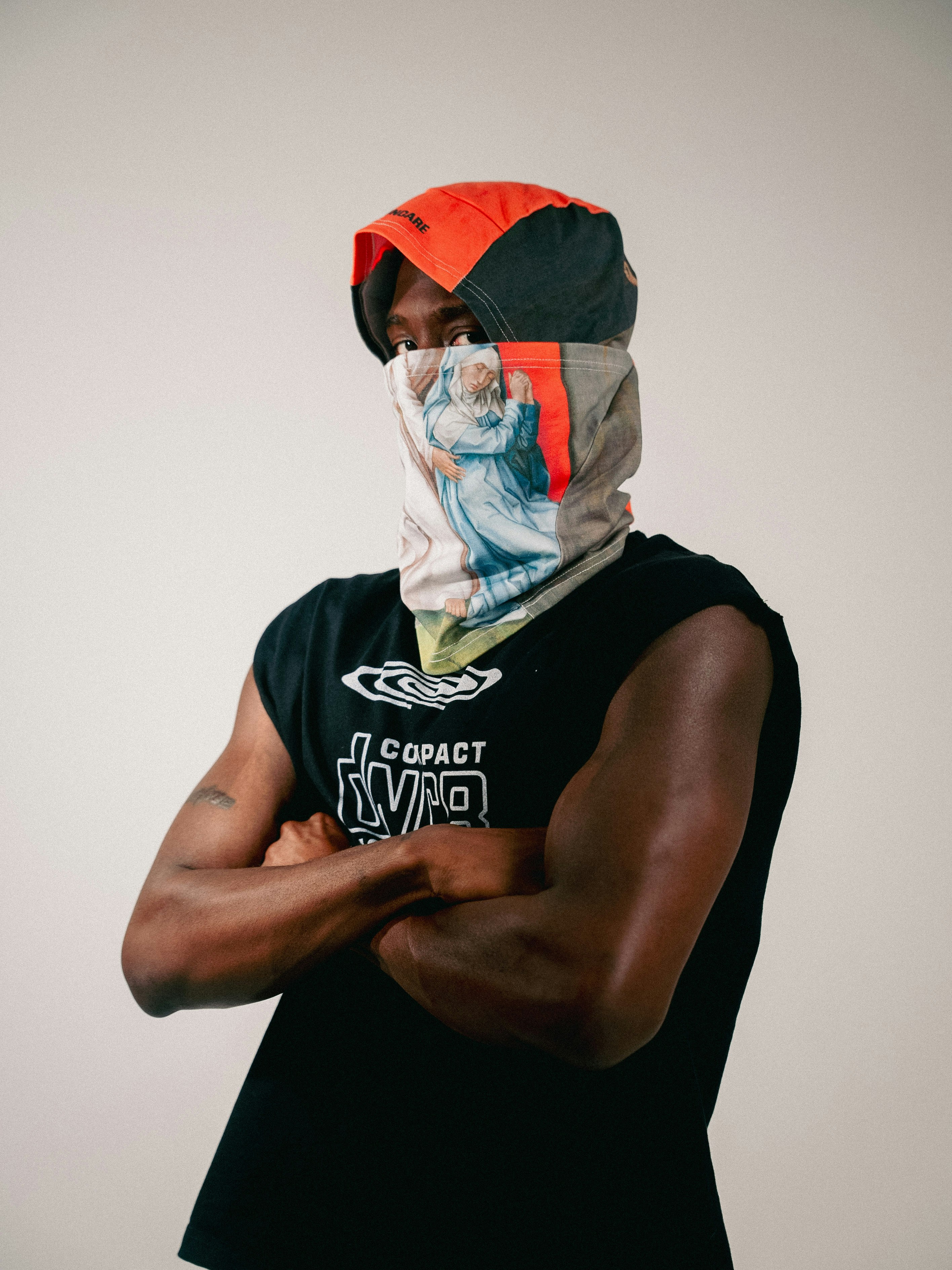 Man with patterned face covering and black shirt