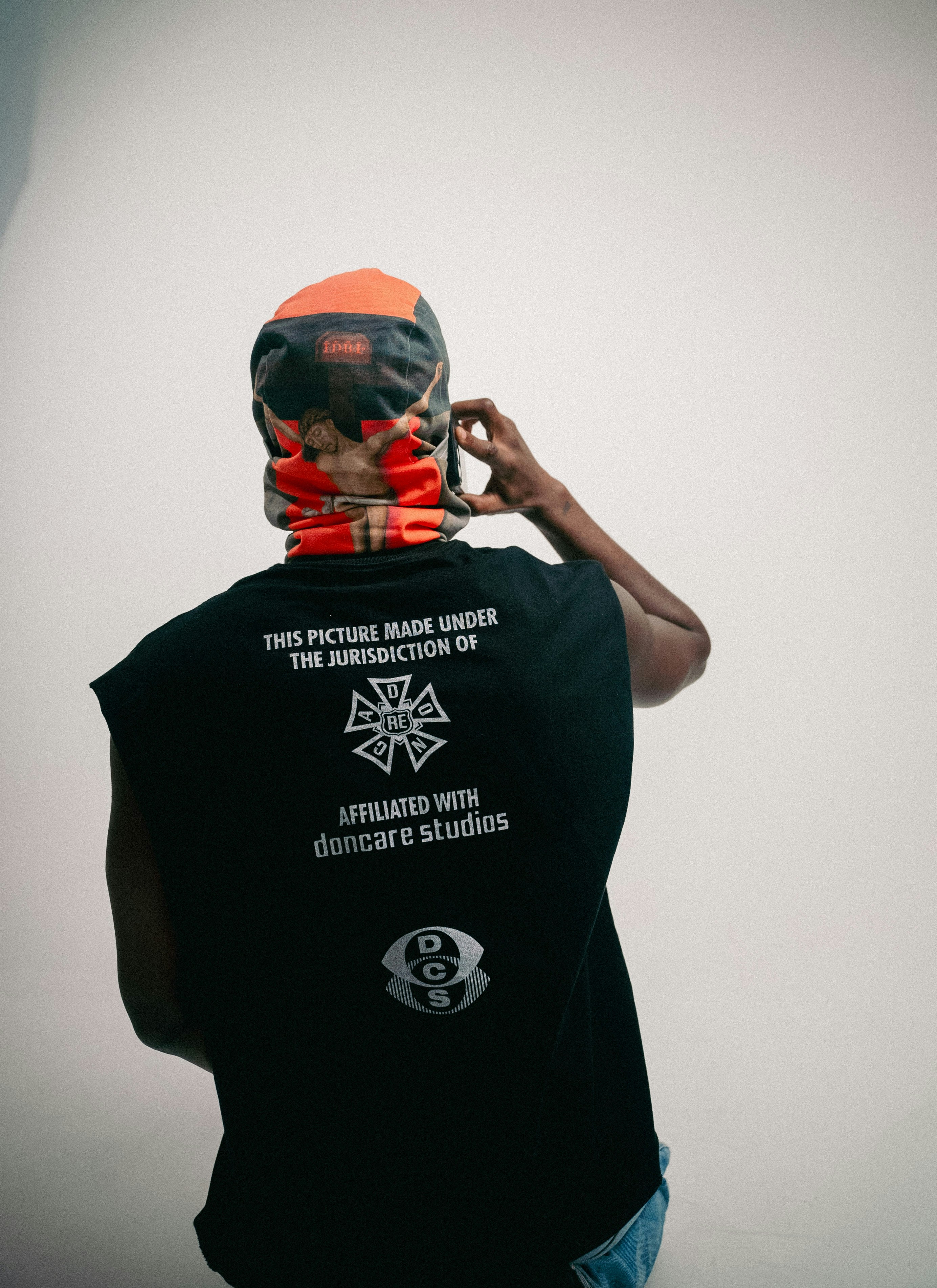 Person wearing a bandana and t-shirt on phone