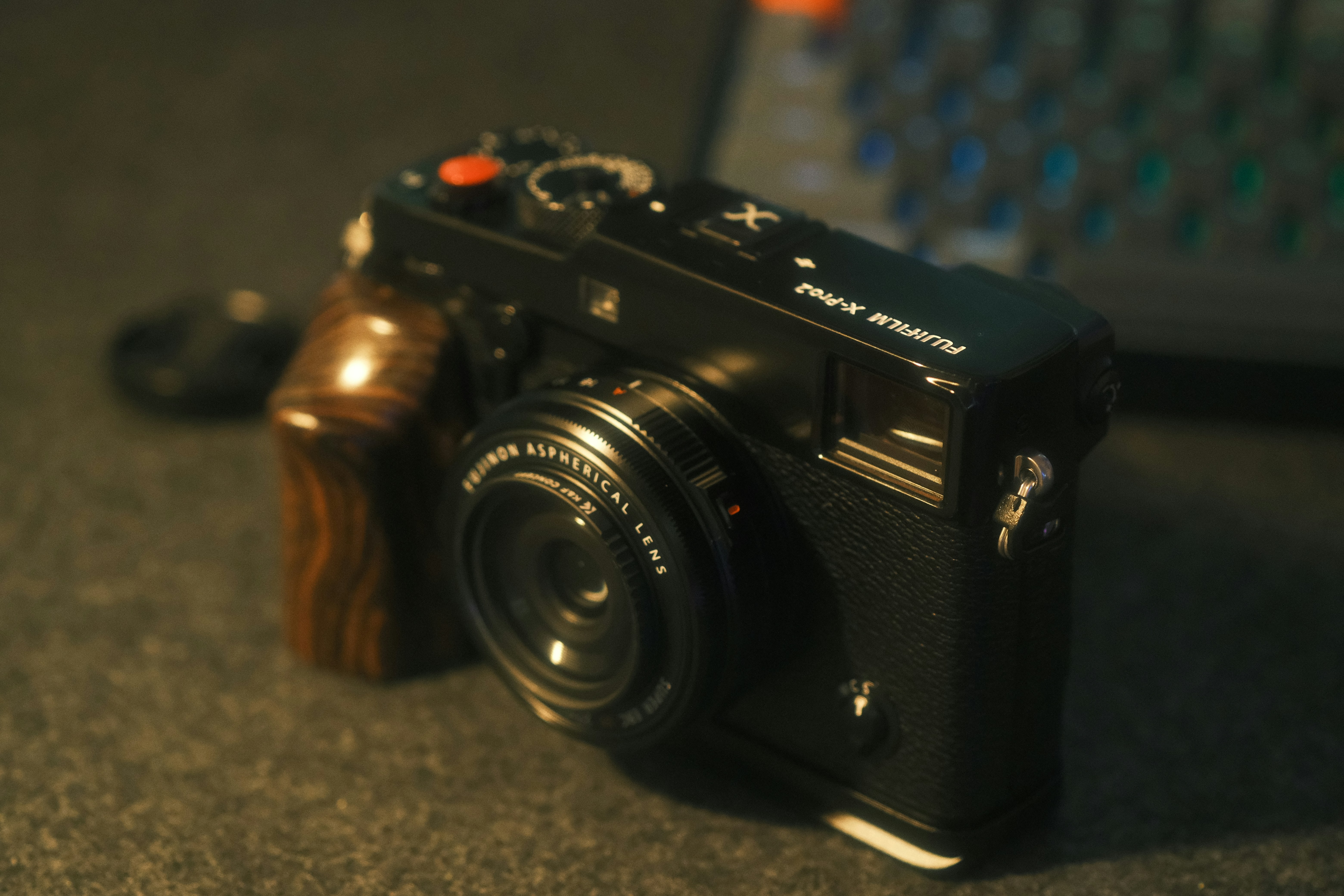 A black fujifilm camera with wooden grip.