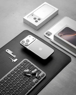 Apple iphones and accessories arranged on a surface.
