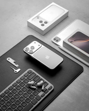 Apple iphones and accessories arranged on a surface.