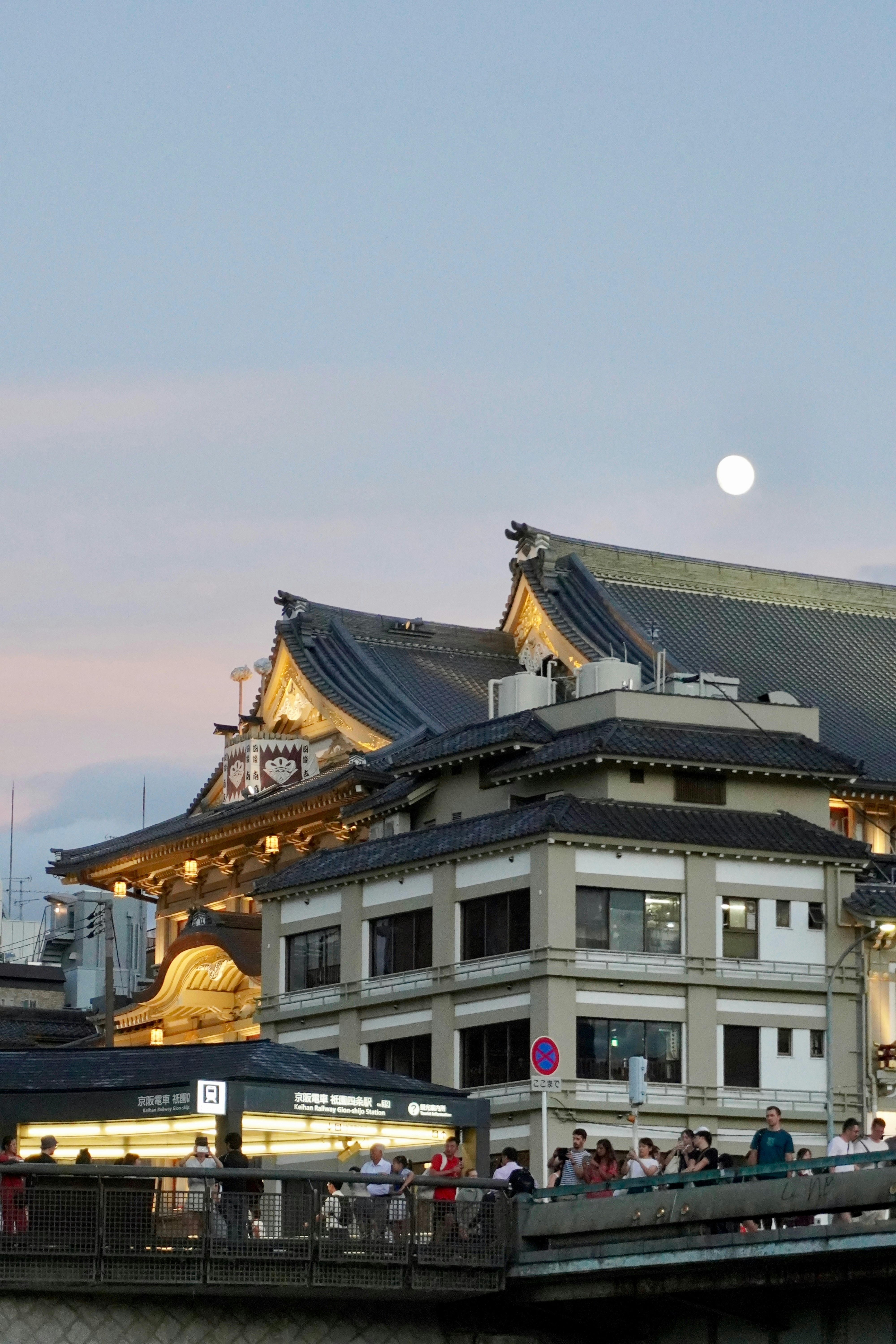 Traditional japanese buildings under a full moon sky