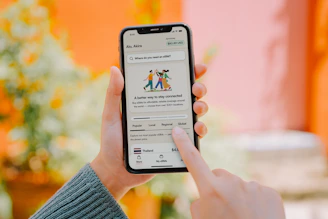 Person using a smartphone with colorful background.
