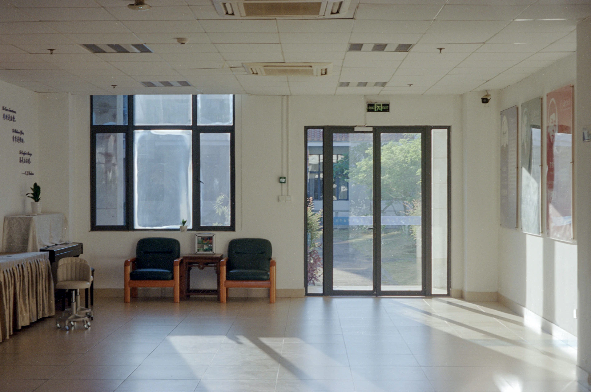 Sunlight streams into an empty waiting room with chairs.