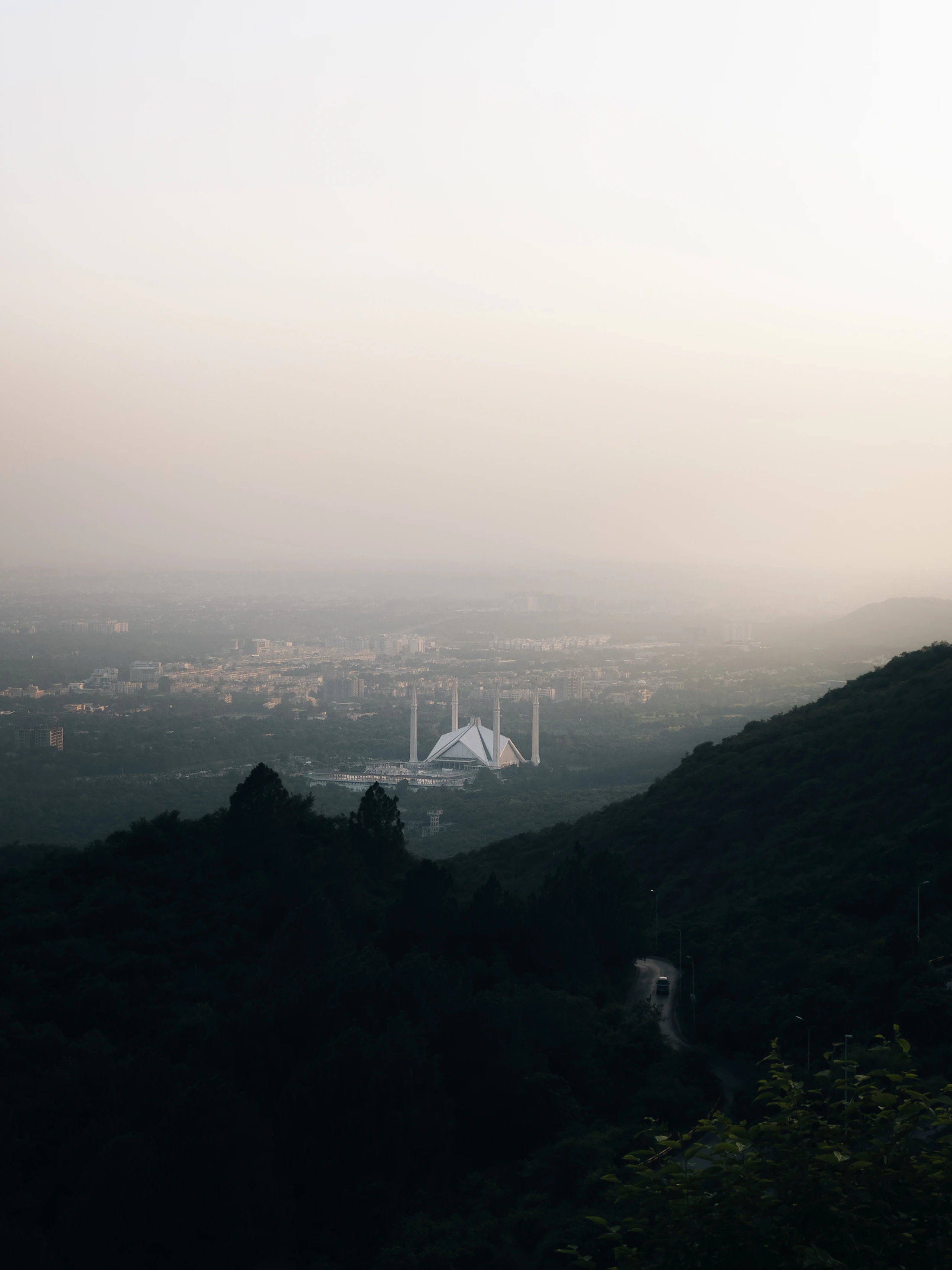 Faisal Mosque and the Islamabad cityscape at dusk