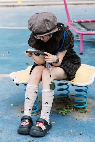 Young woman playing a video game outdoors