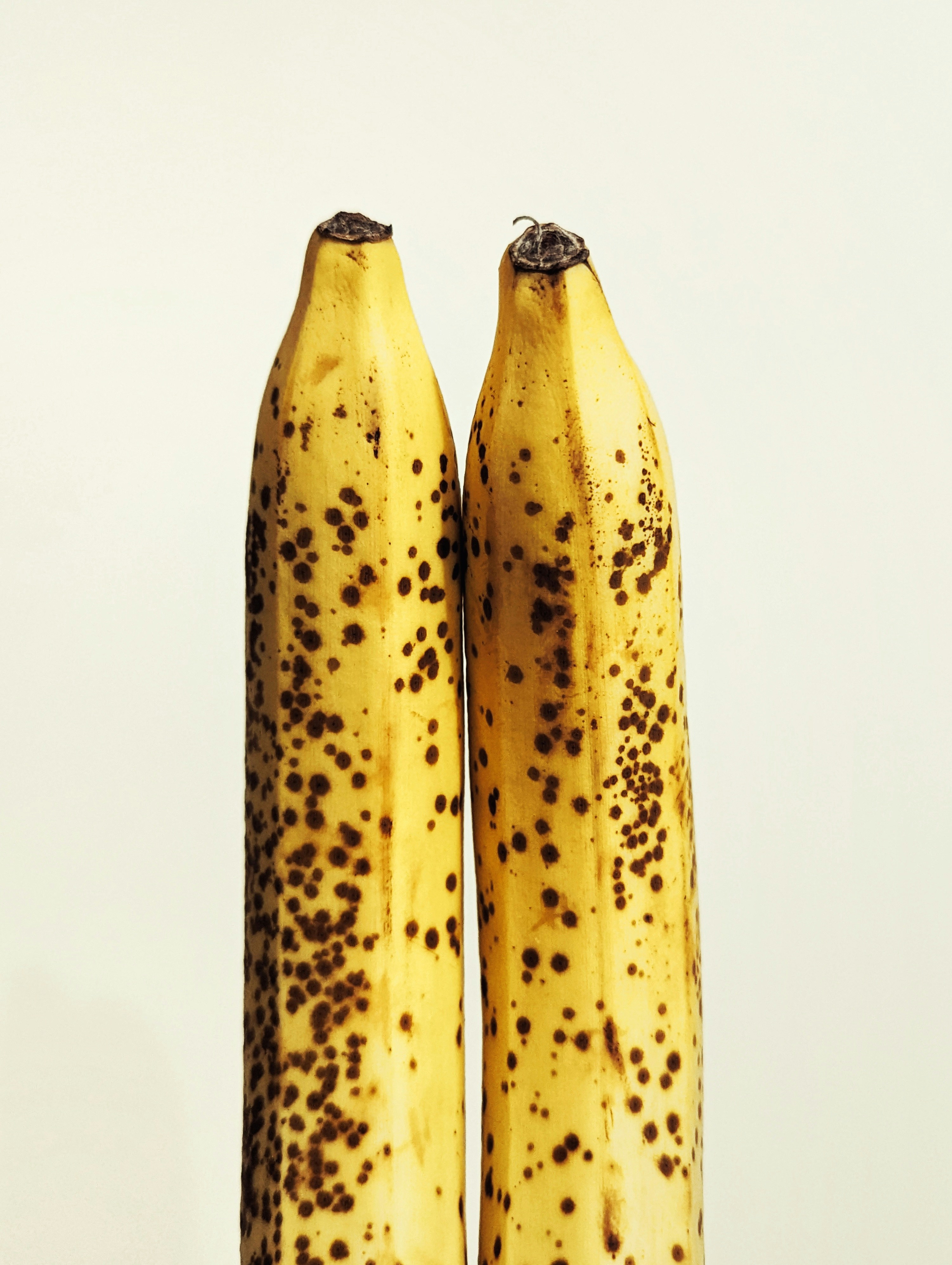Two ripe bananas with brown spots