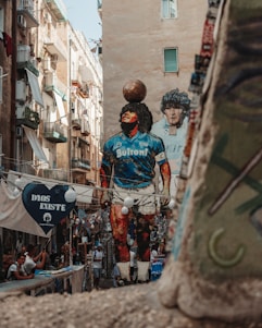 Giant mural of diego maradona in a narrow street