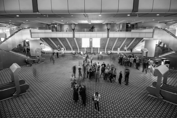 Orlando convention center - People gathered in a large, modern atrium with escalators.