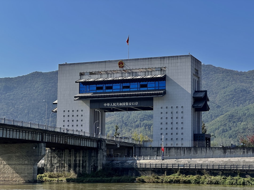 Modern building with bridge over river and mountains