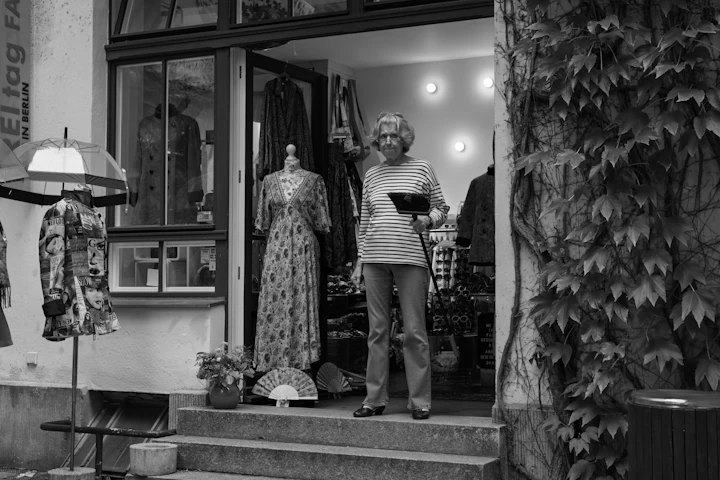 Woman standing in a vintage clothing store entrance