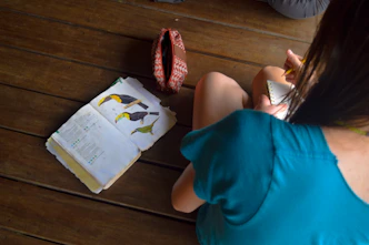Woman looking at a book with bird drawings