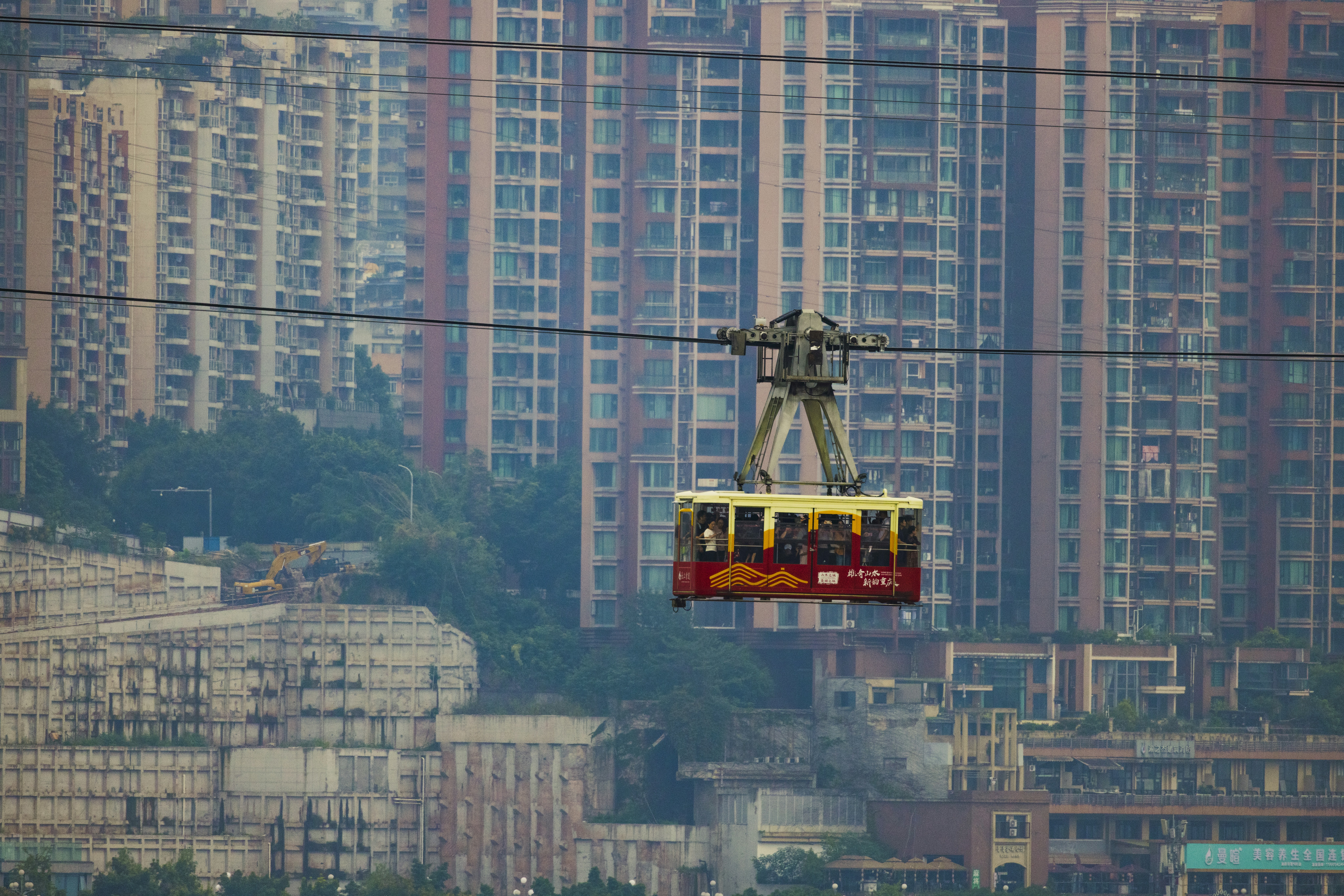 Cable car with passengers against city buildings