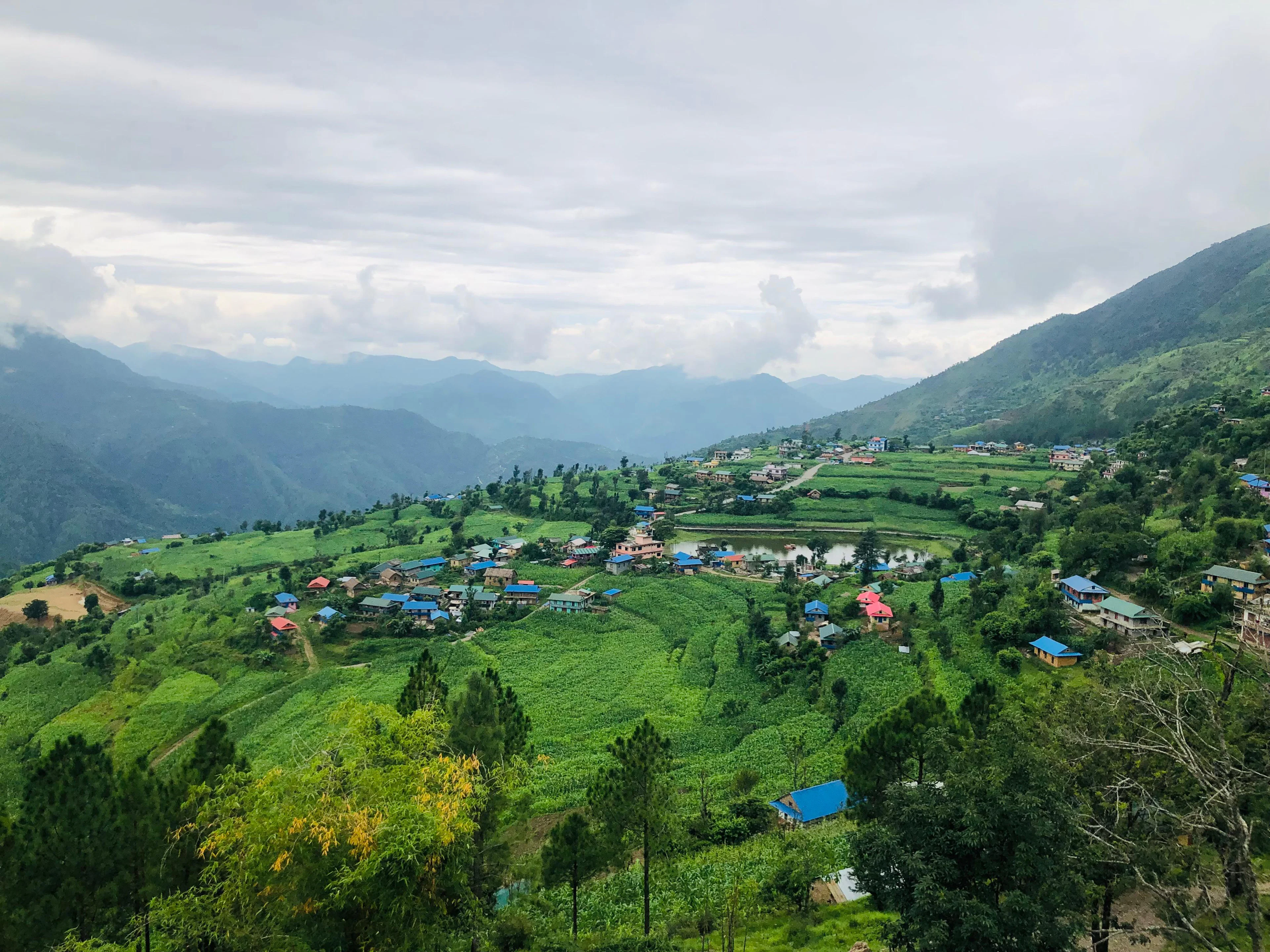 Village and green terraced land on rolling hills