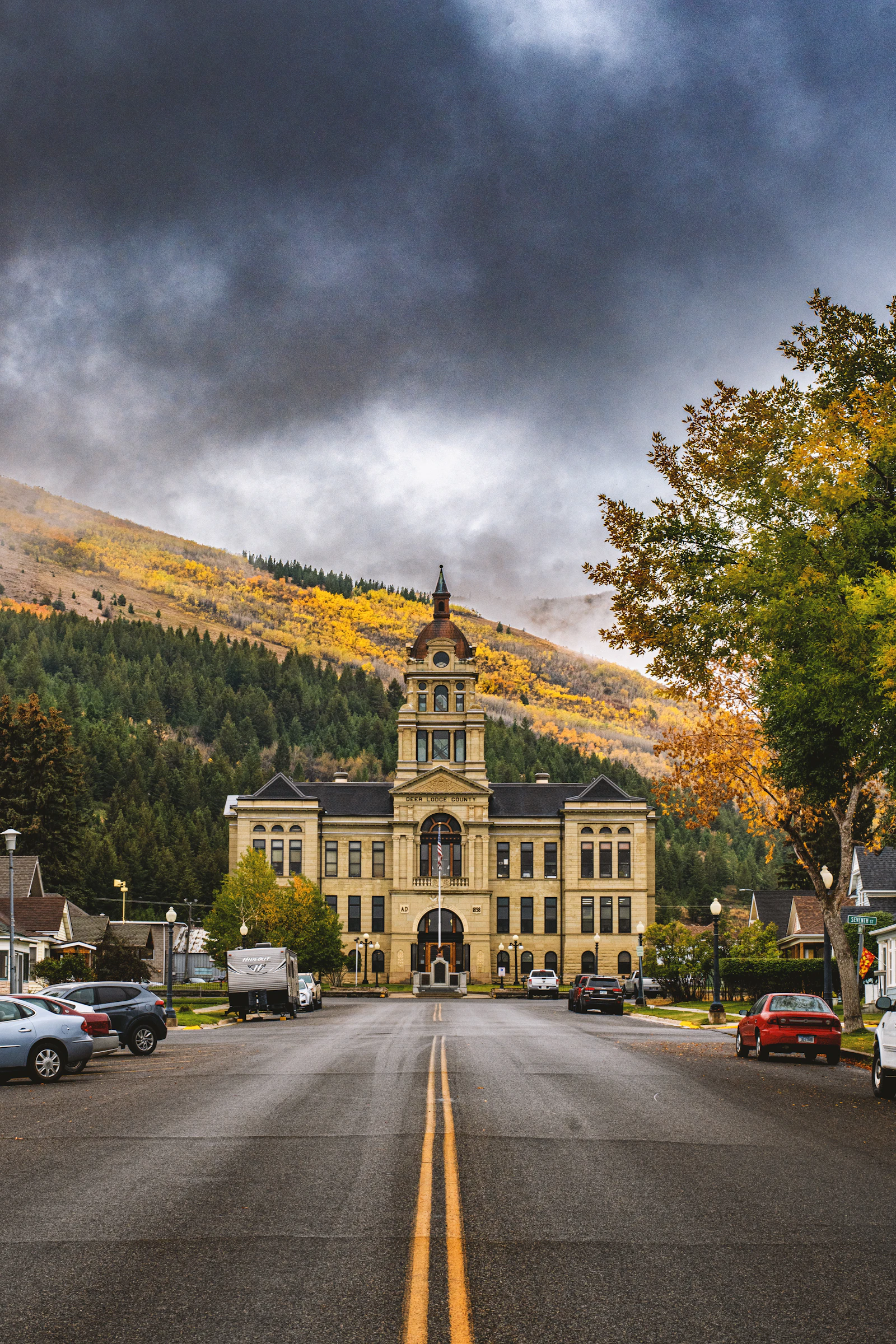 Historic courthouse building surrounded by autumn trees