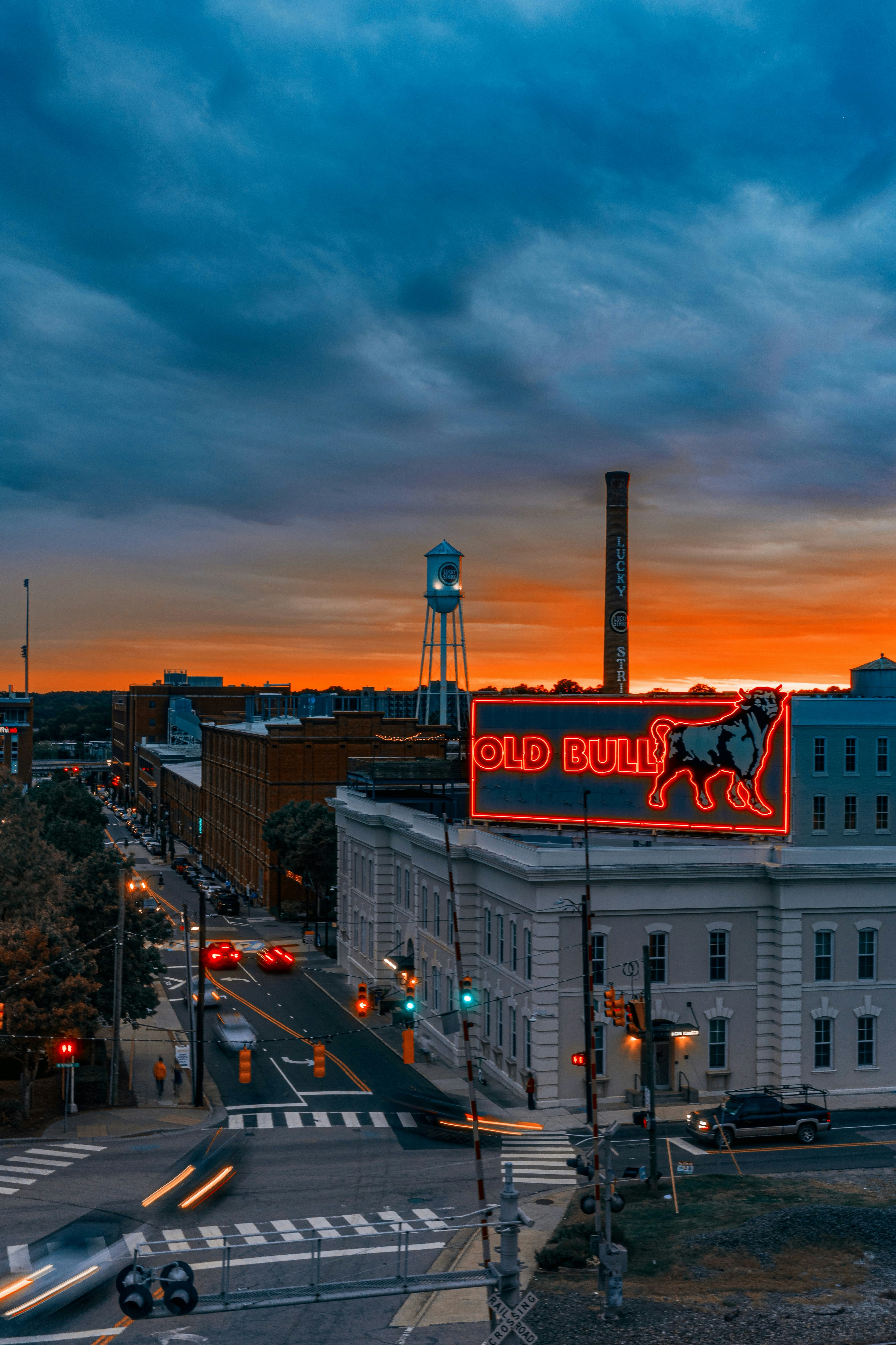Cityscape at sunset with old bull sign illuminated