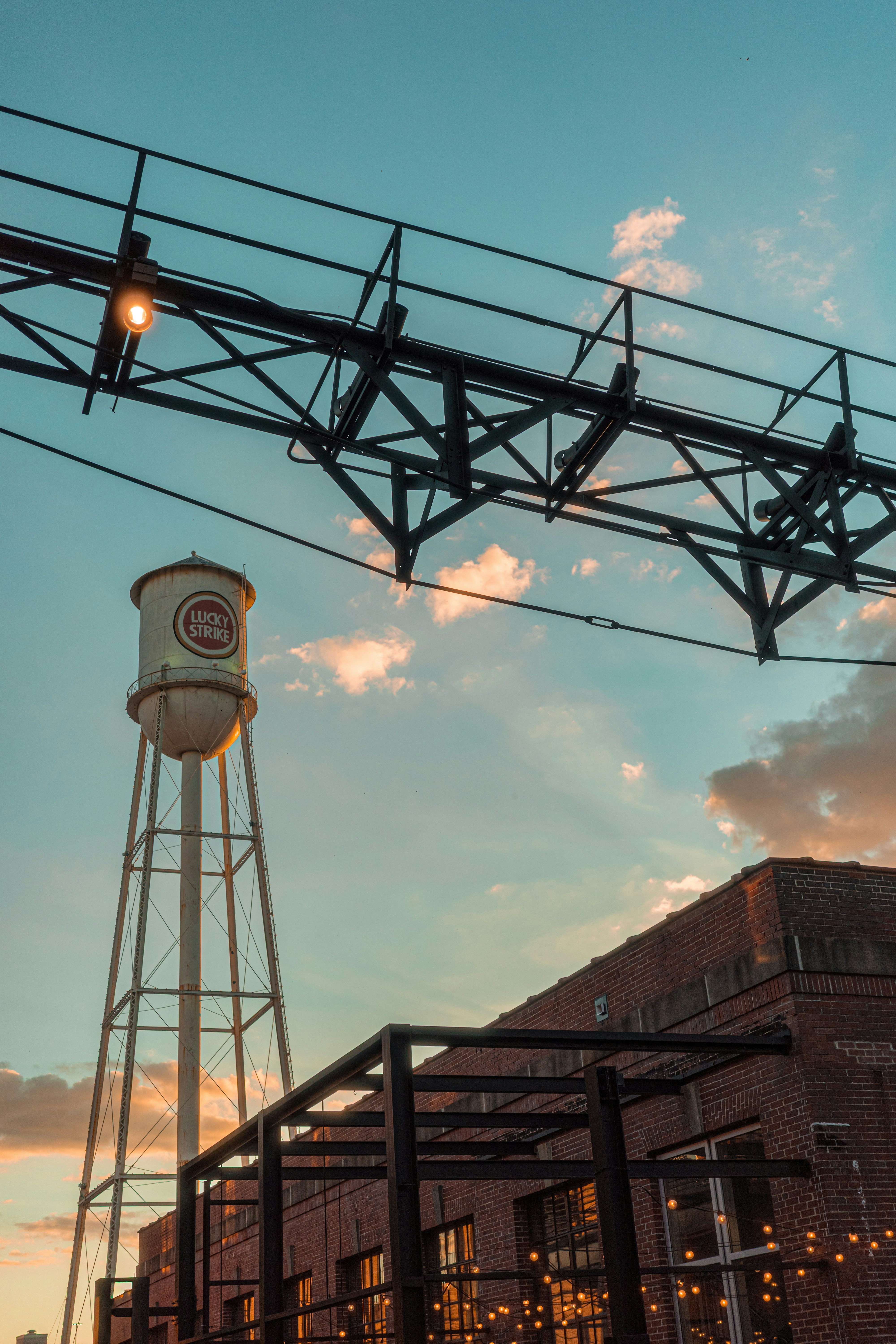 Water tower and brick building at sunset