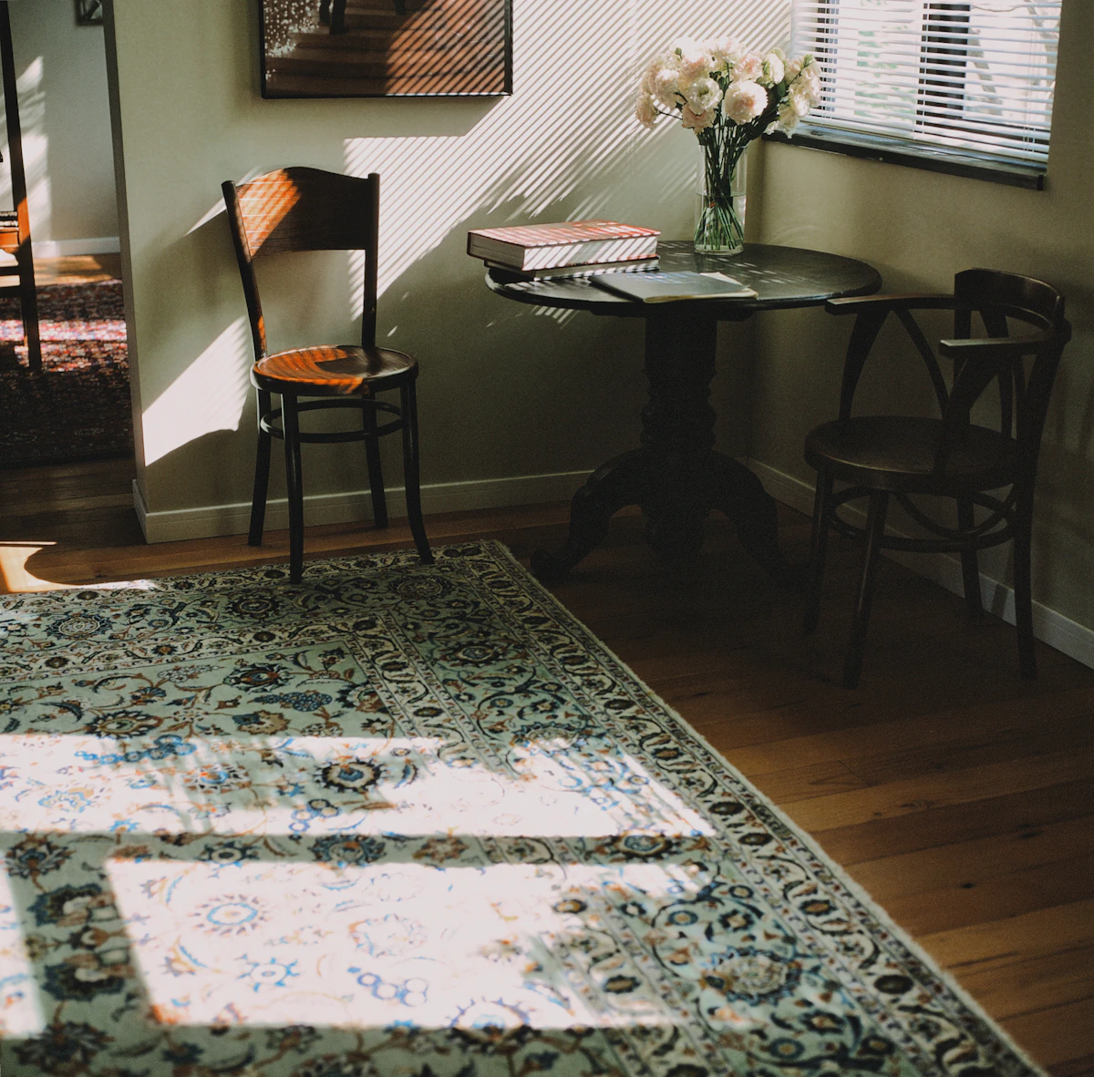Sunlit rug anchoring a cozy reading corner with chairs