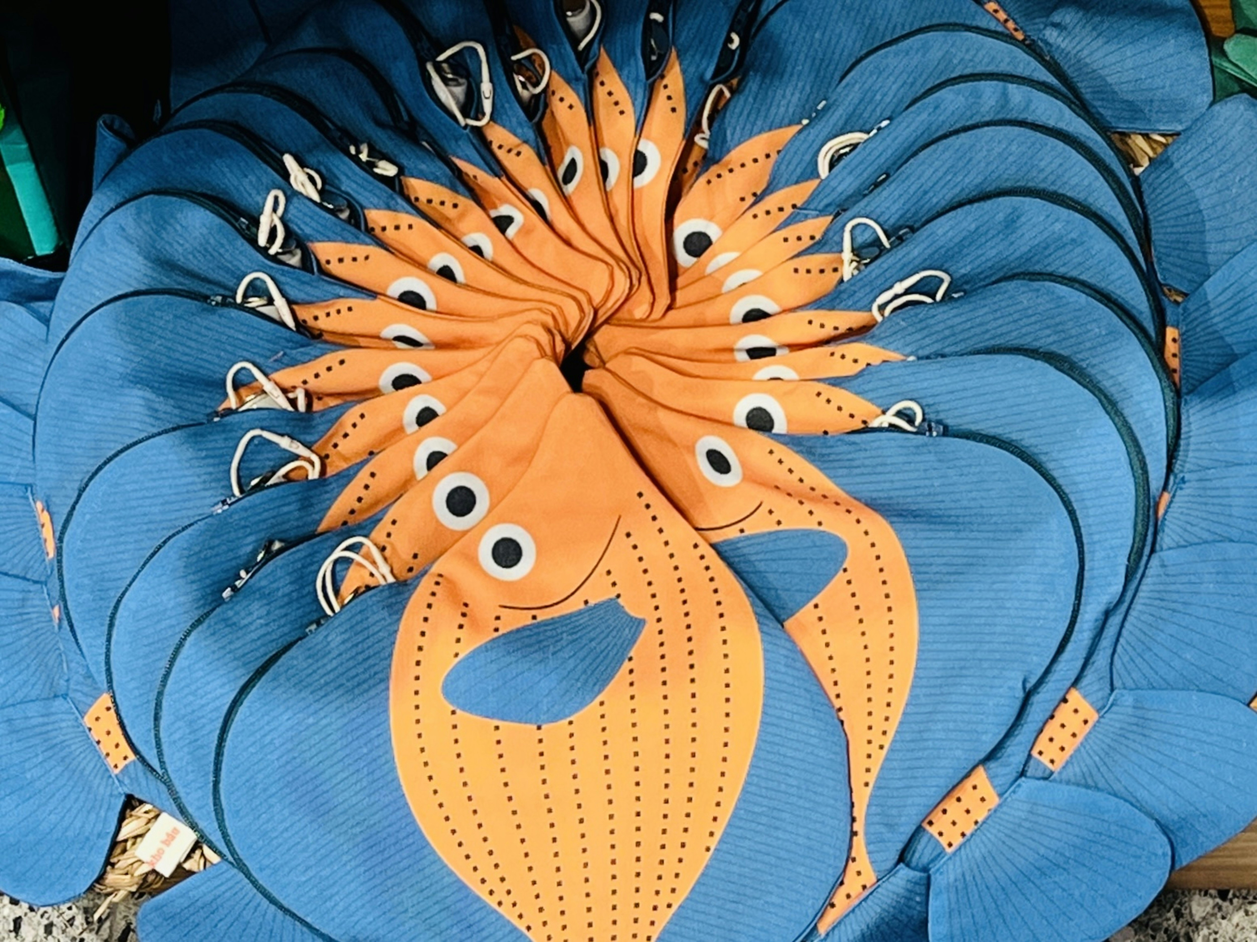 Stack of blue and orange fish-shaped fabric items.