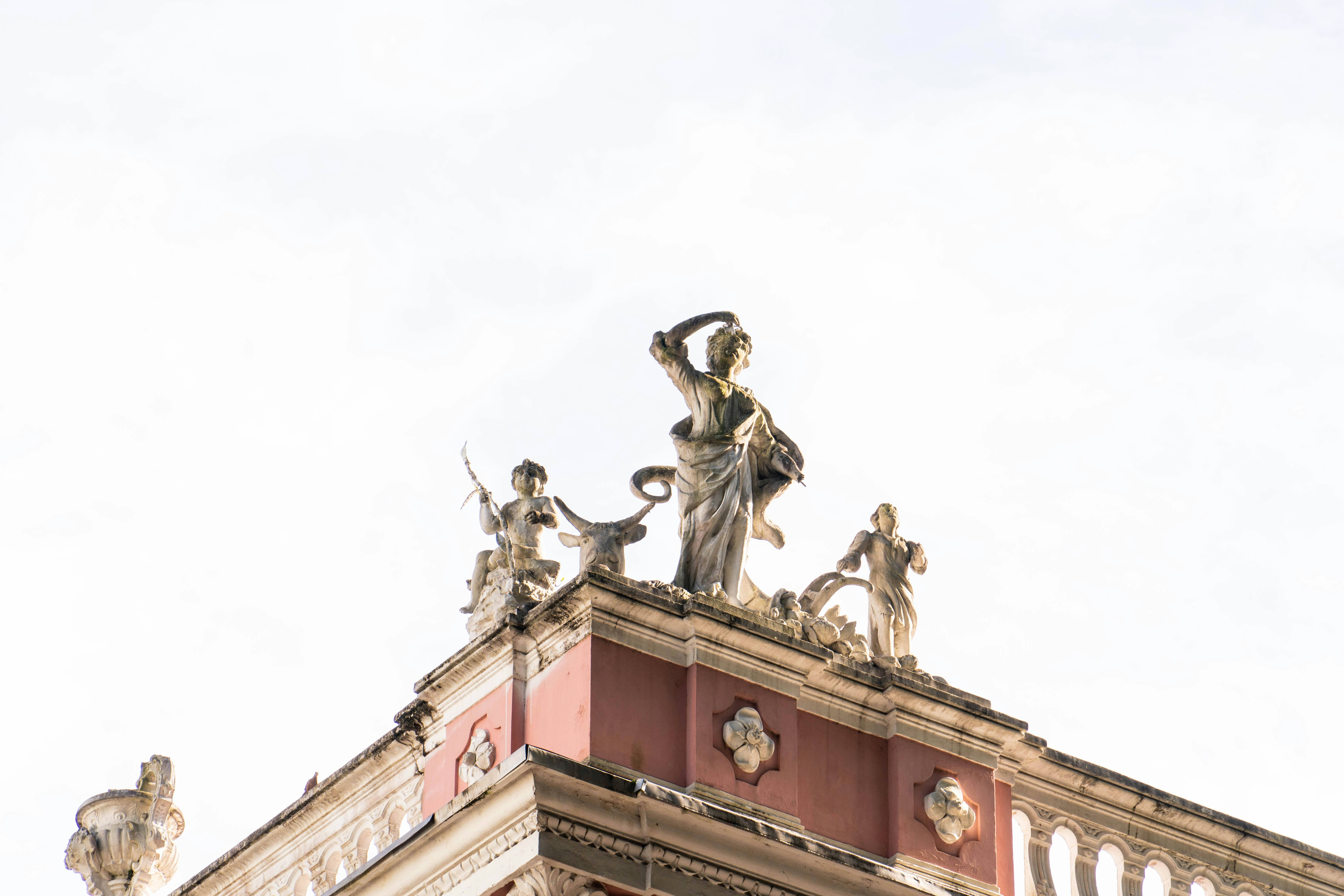 Architectural statues on a building rooftop