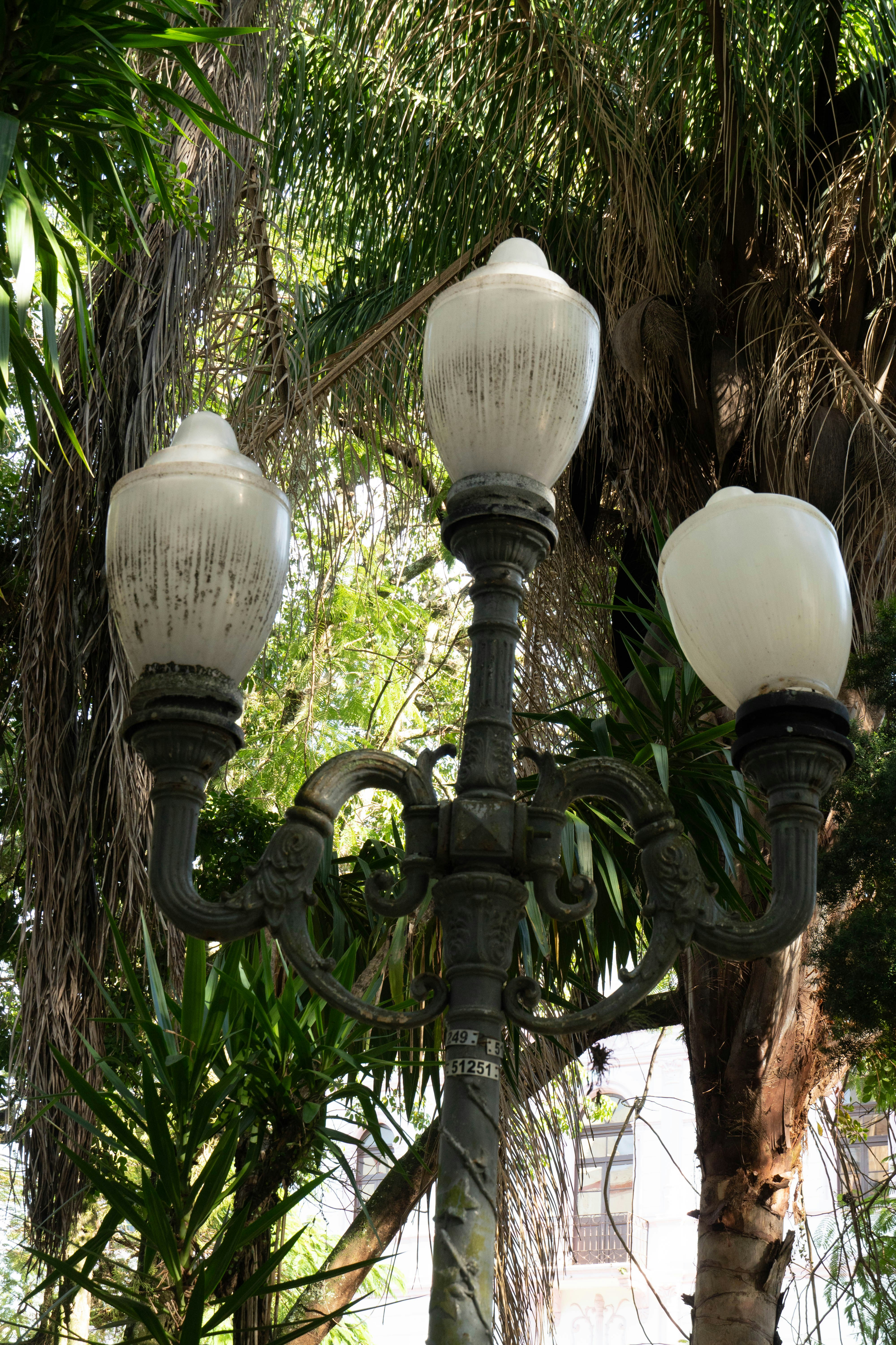 Ornate vintage street lamp with three globes