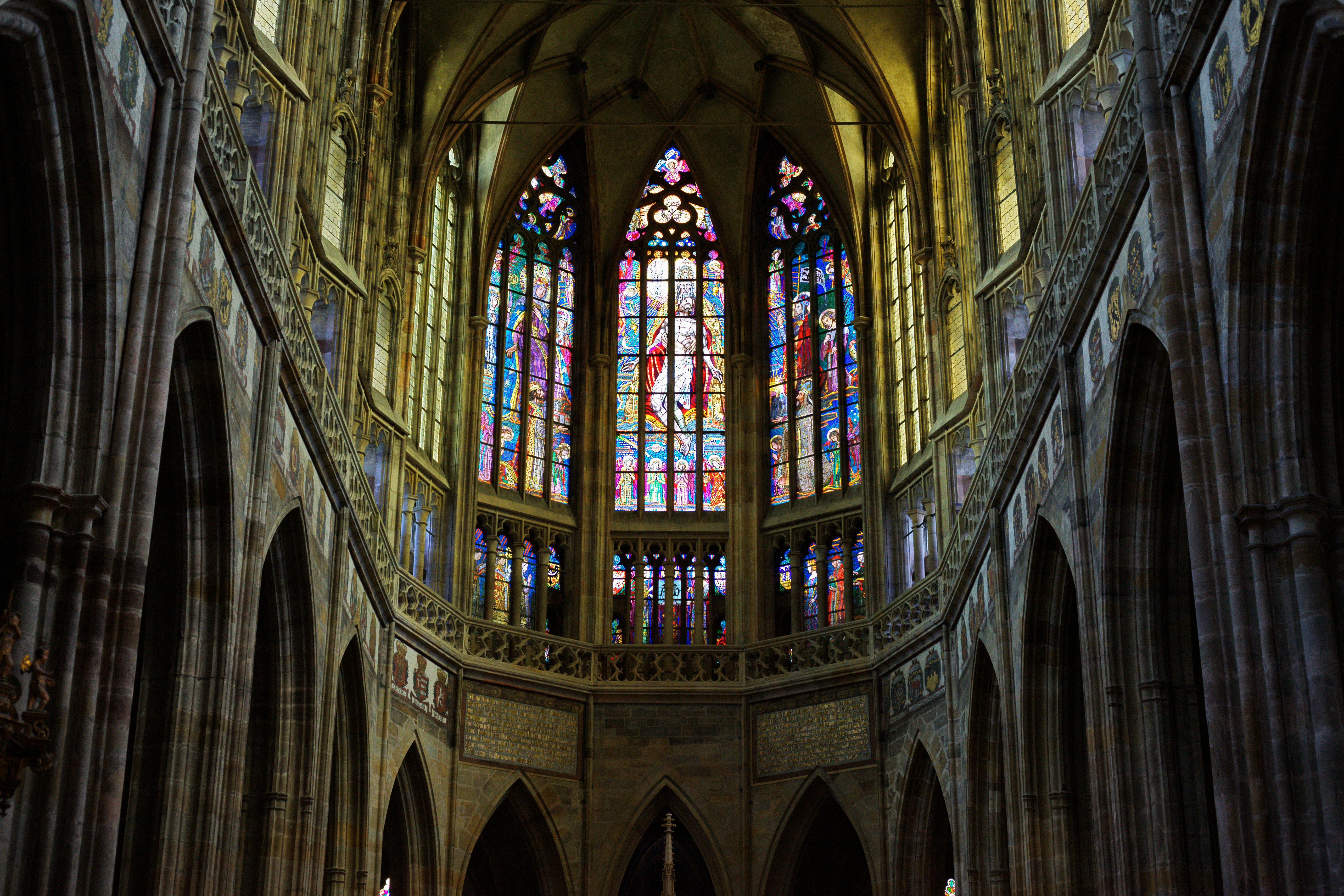 Gothic cathedral interior with large stained glass windows.