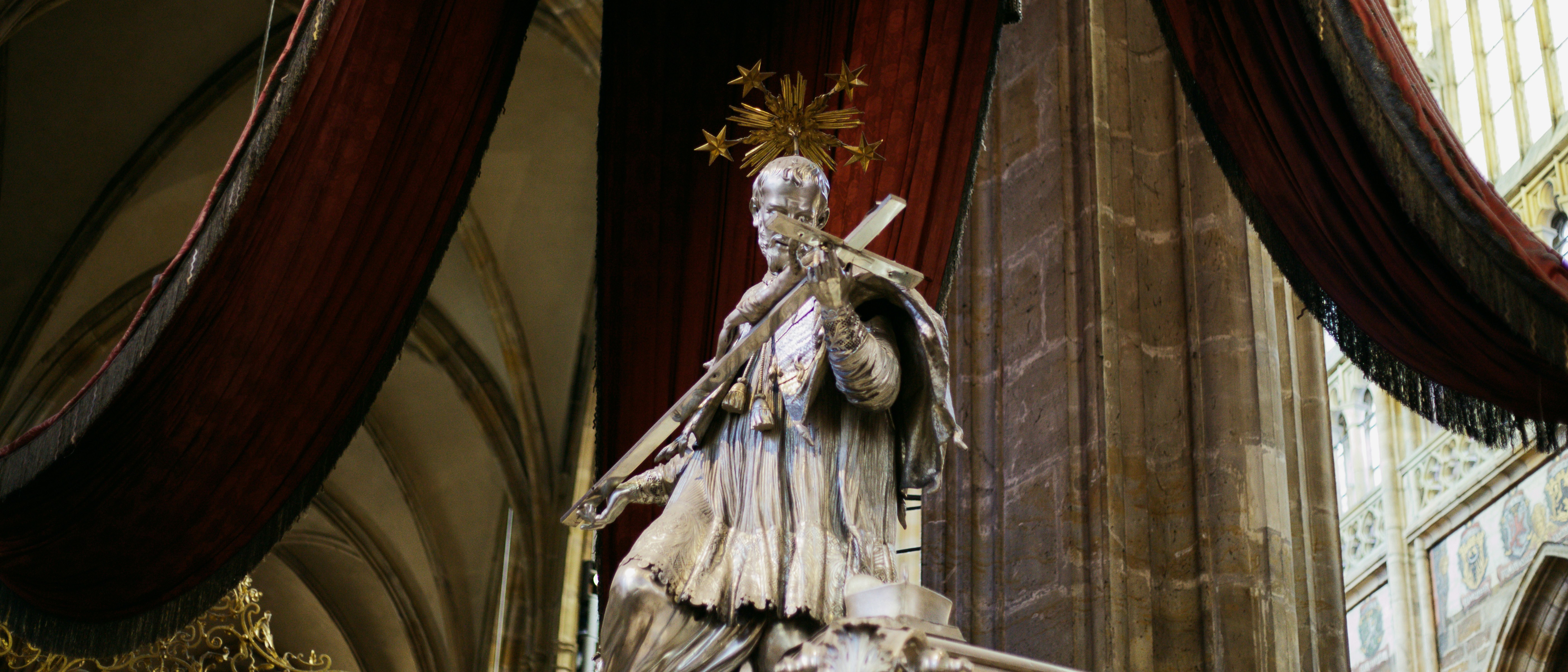 Marble statue of a saint holding a cross