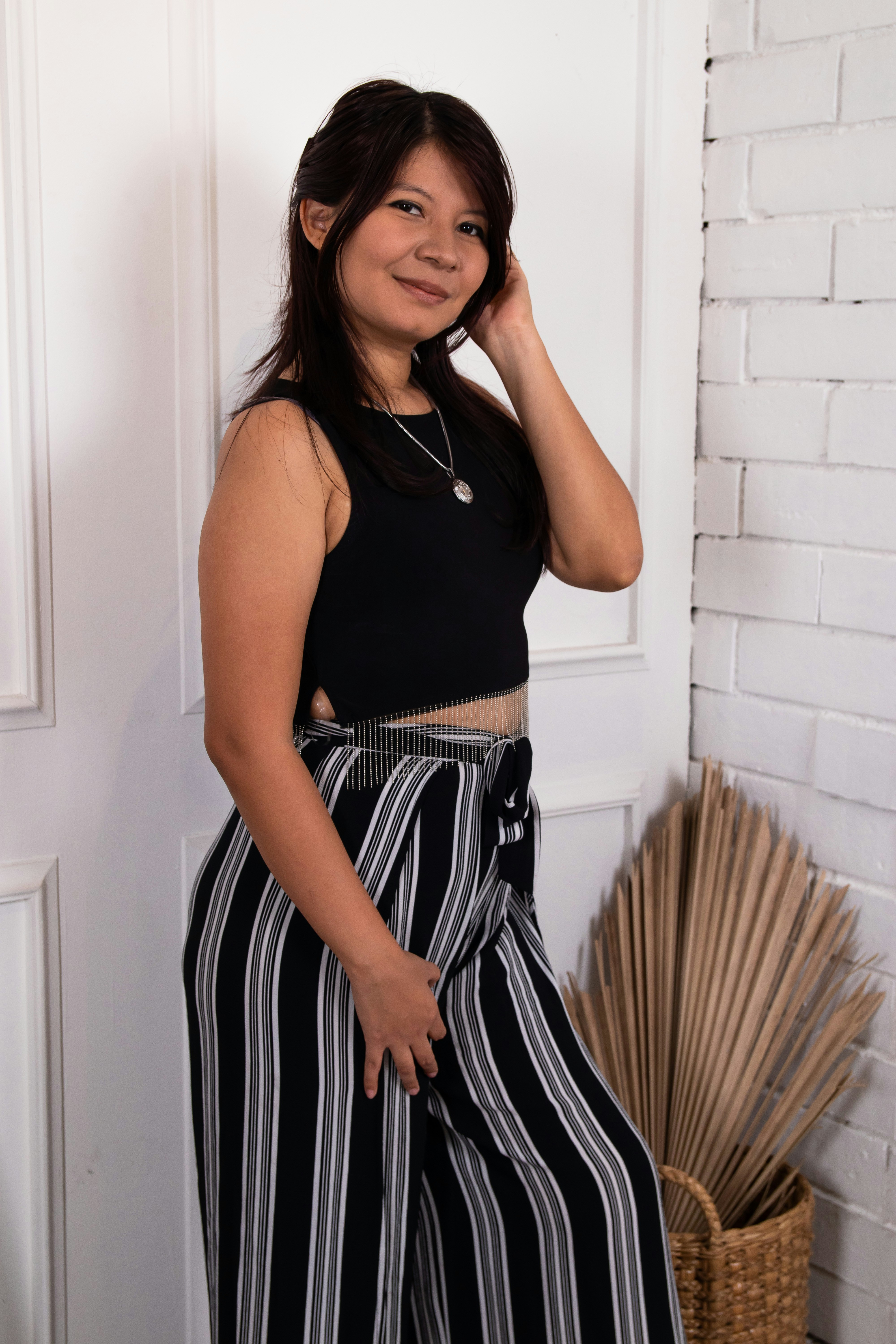 Woman in black crop top and striped pants