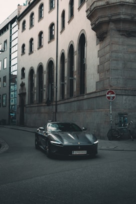 Dark luxury convertible driving on city street