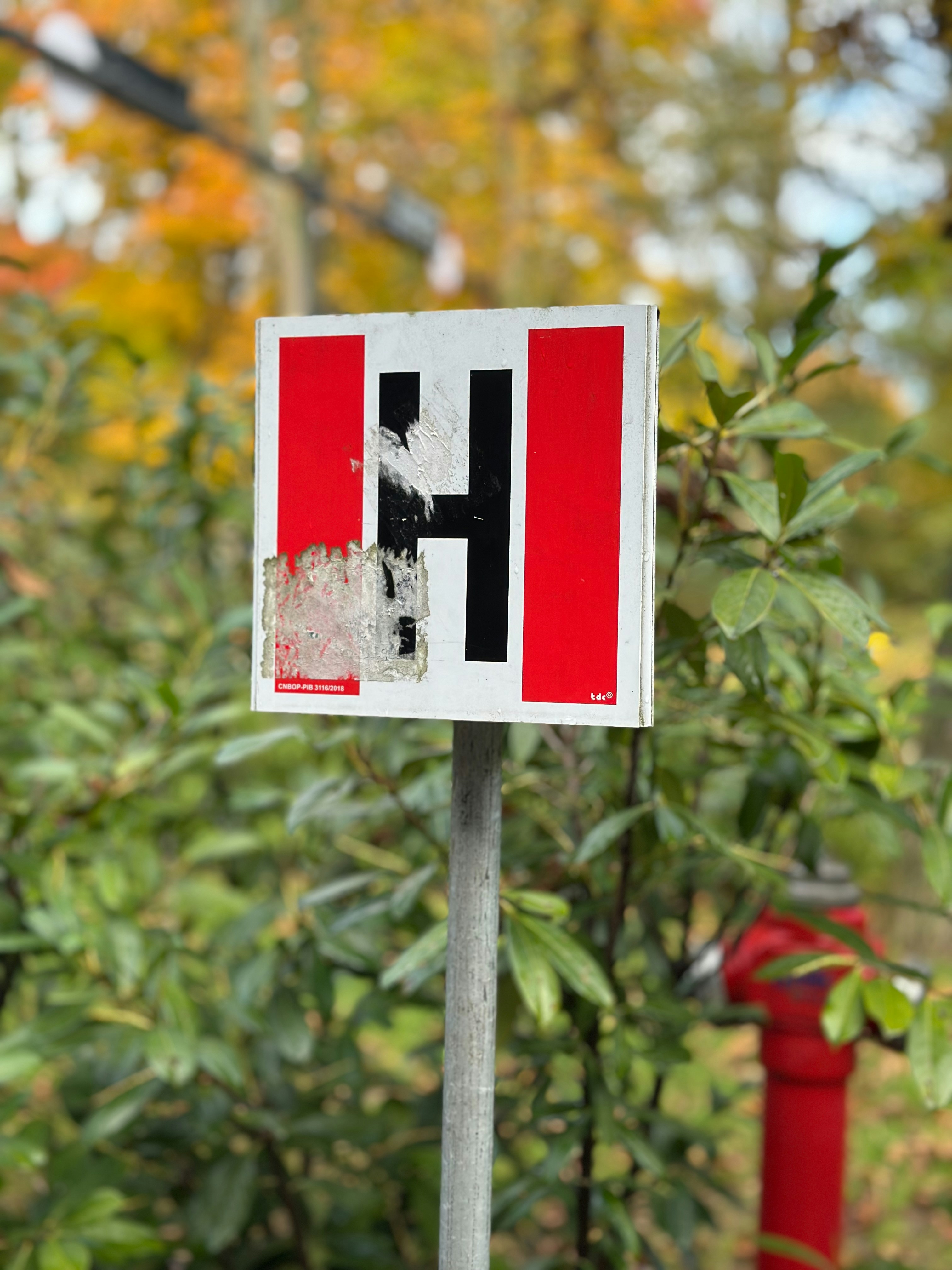 Sign with letter h and red stripes