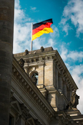 German flag flying atop a historic building