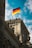 German flag flying atop a historic building