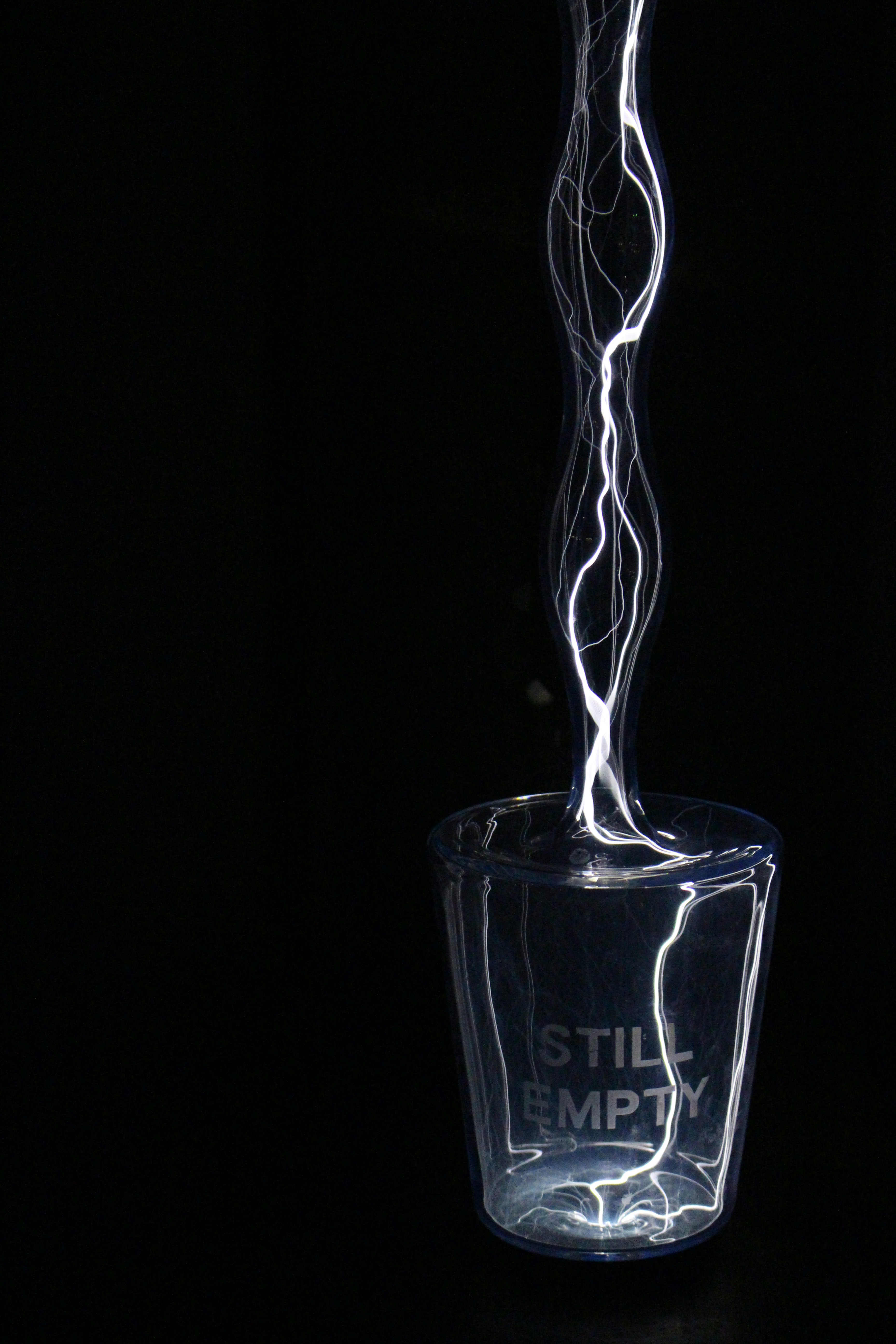 Abstract lightning-like energy flowing from a cup.