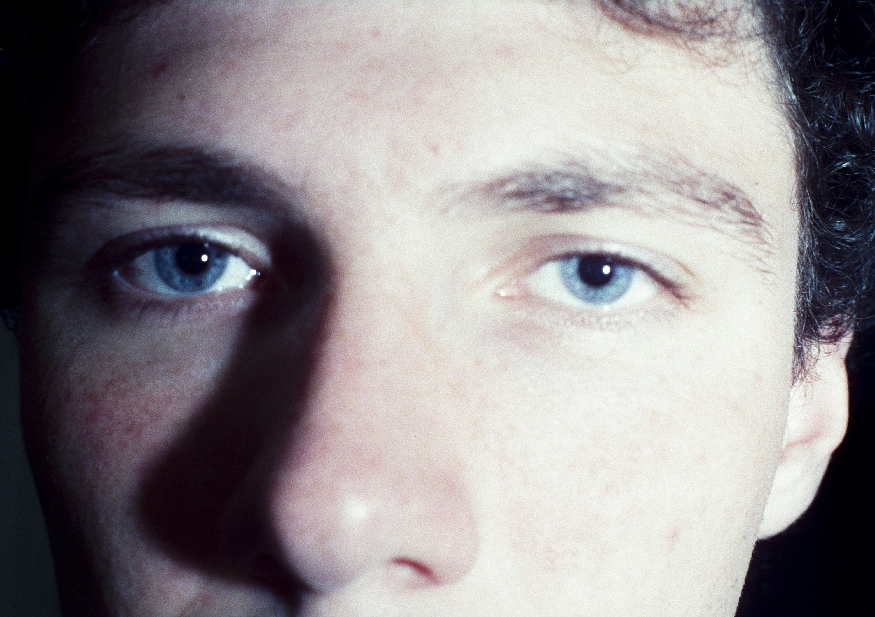Close-up of a person's blue eyes and nose
