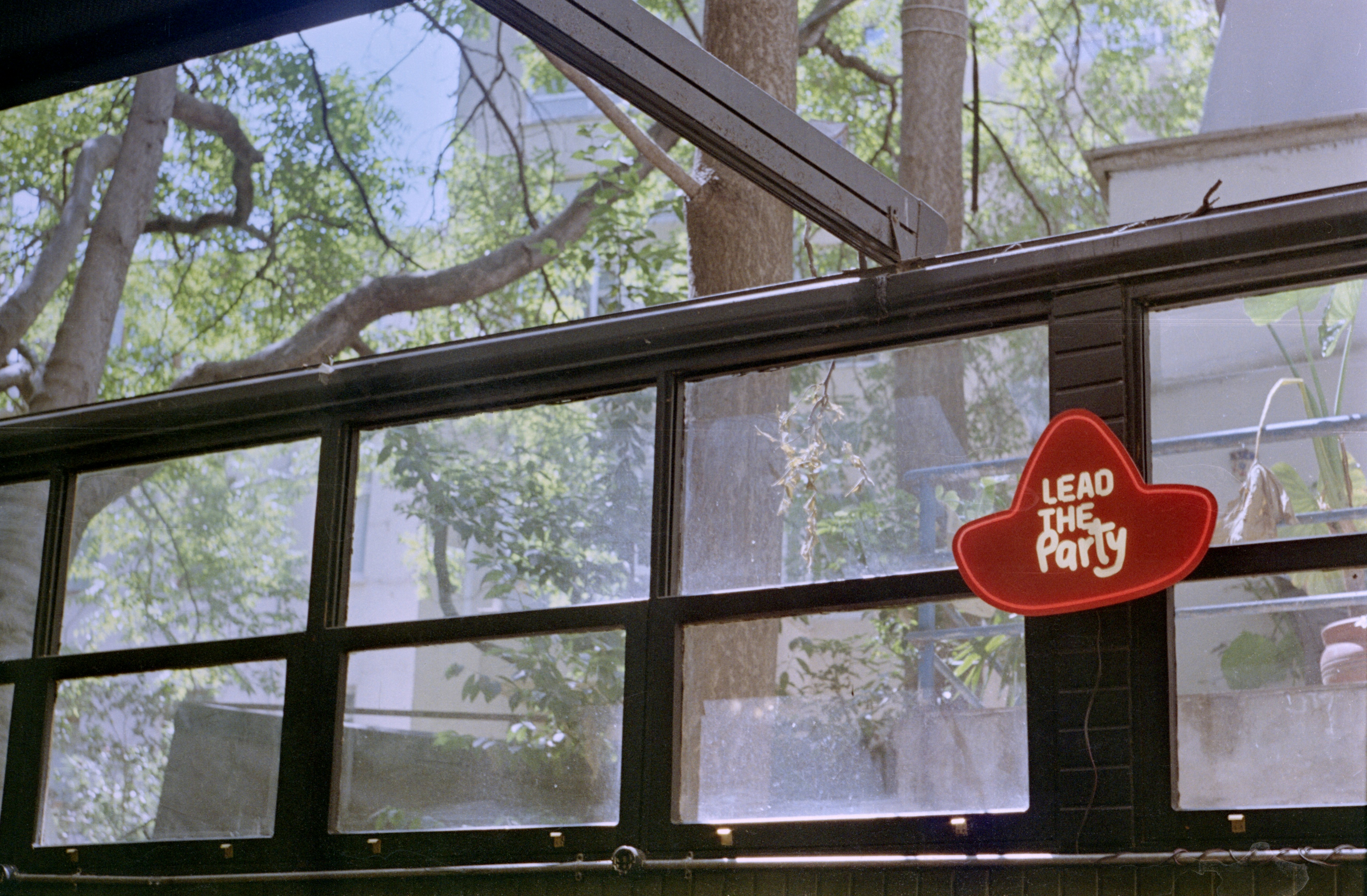 Red hat sign says "lead the party"