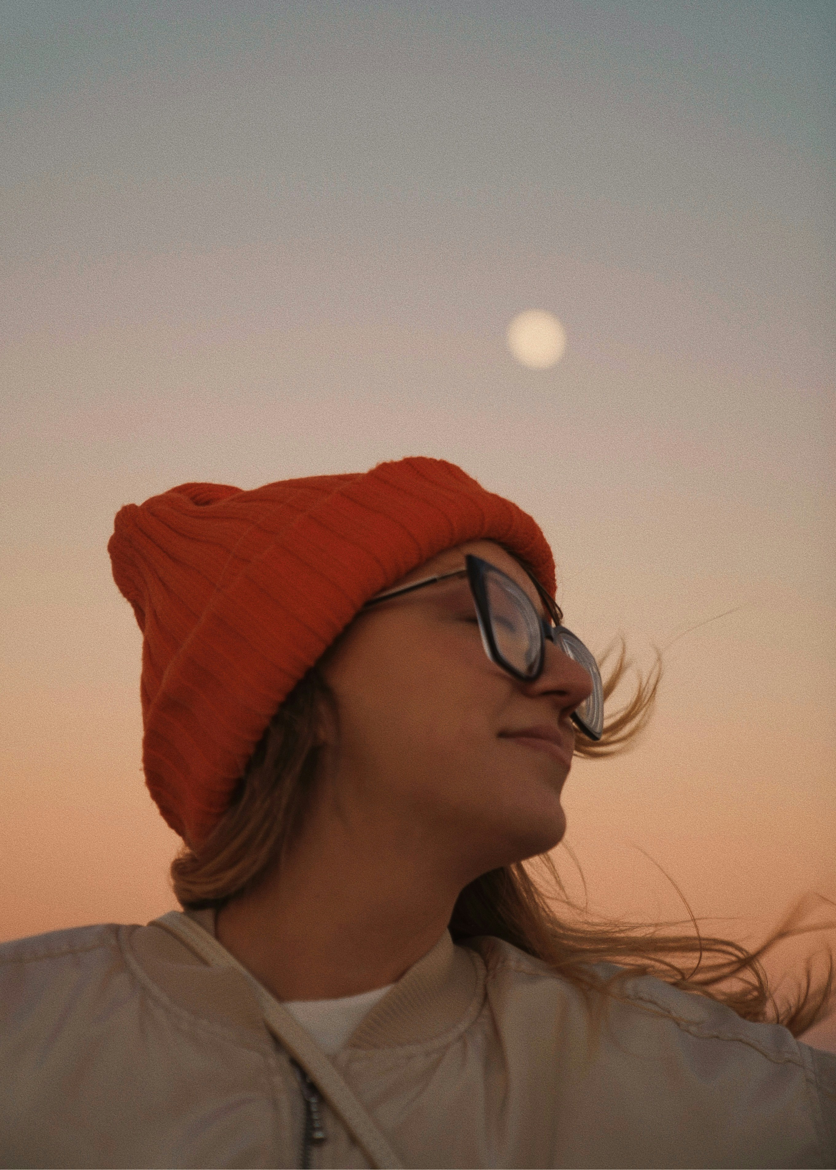 Woman in orange hat looking at the moon