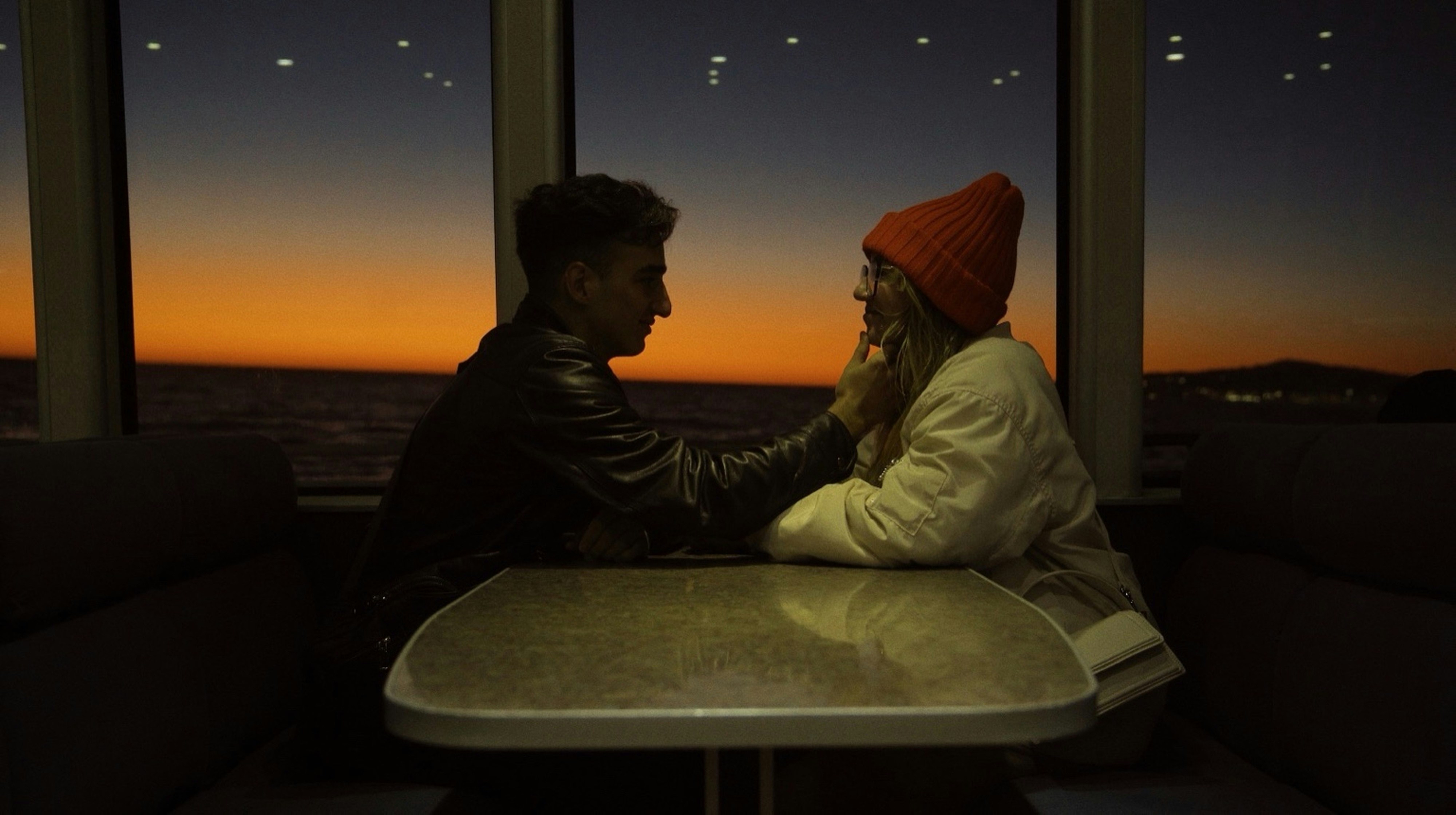 Paar beobachtet den Sonnenuntergang aus einem Bootsfenster