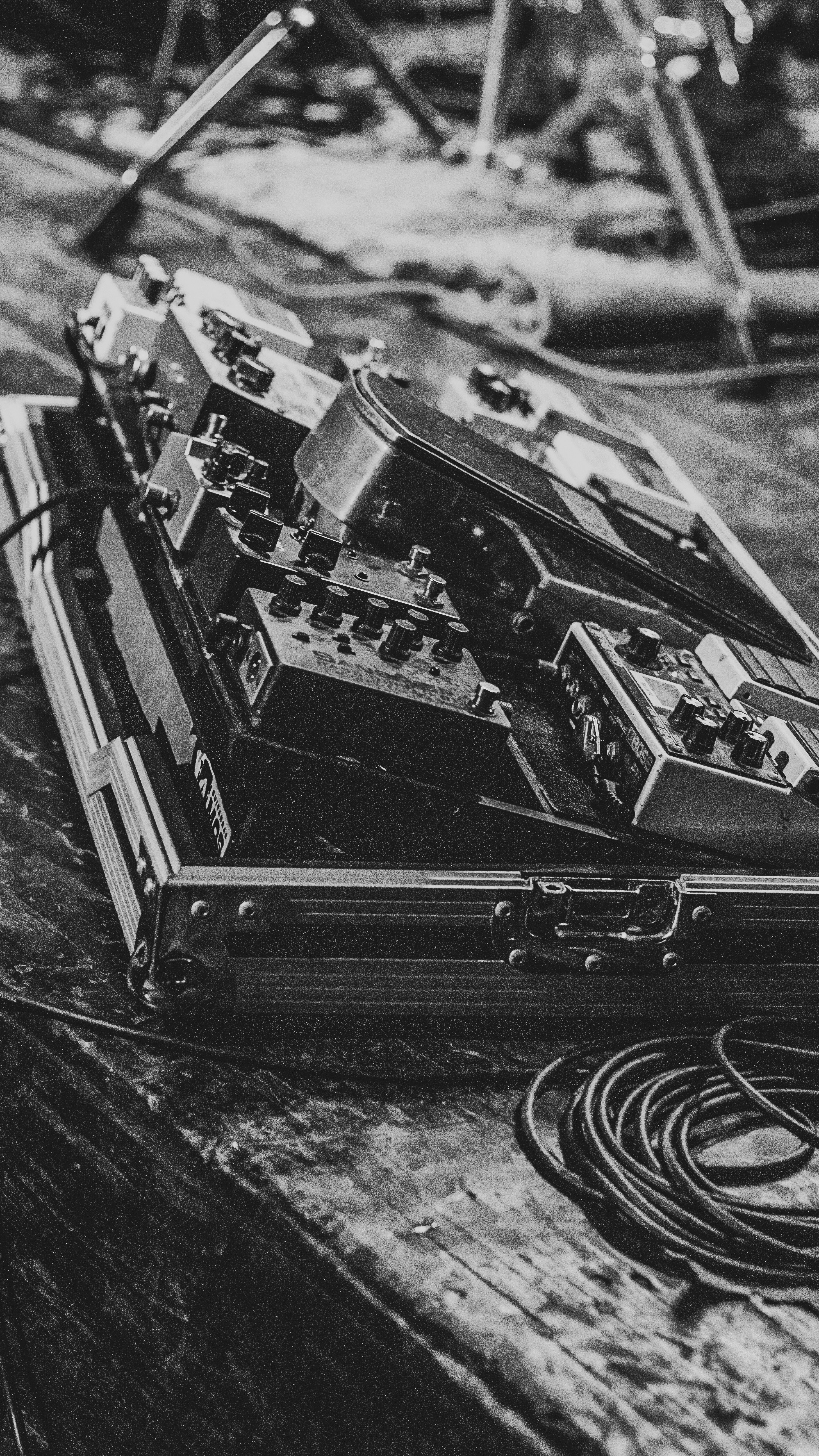 Guitar pedals on a case with coiled cable