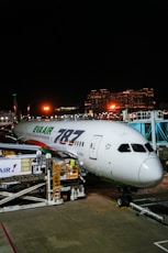 Eva air boeing 787 parked at airport gate at night