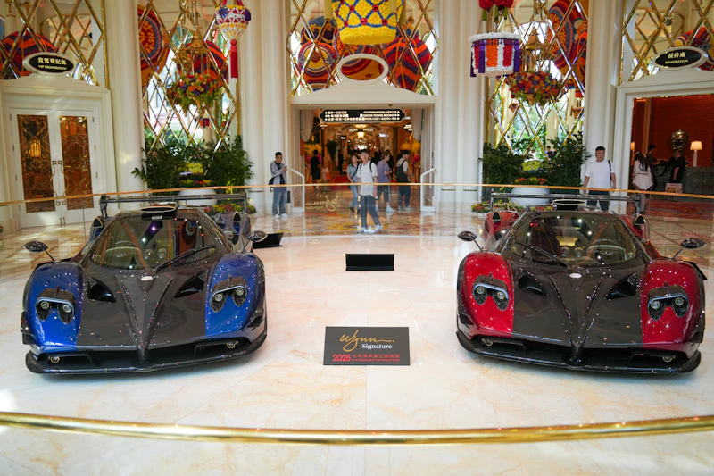 Two sports cars displayed in a grand lobby