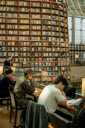 People studying at tables in a large library