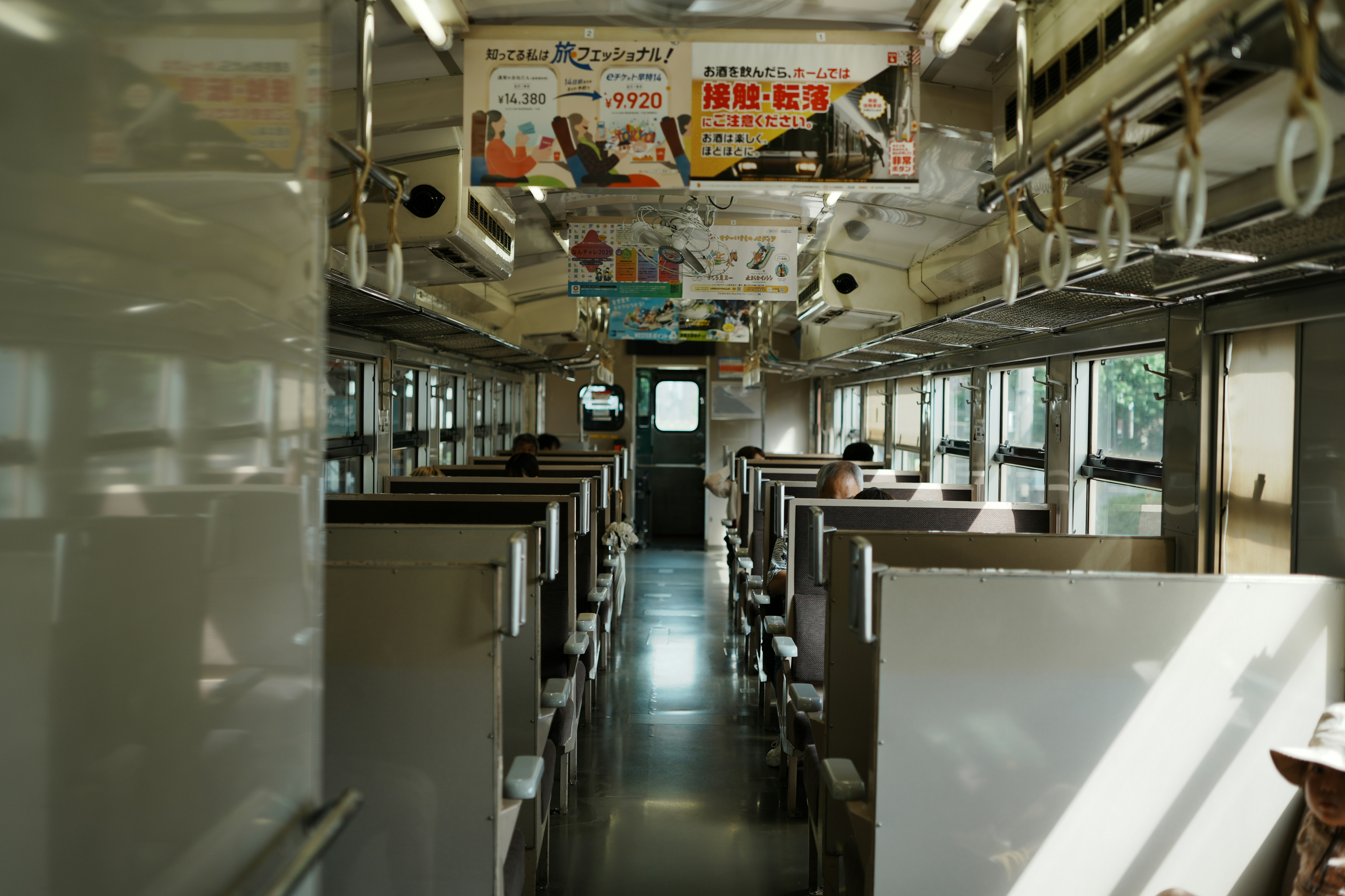 Interior view of an empty train carriage with seats.