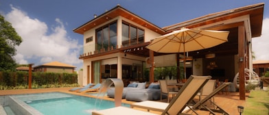Modern villa with swimming pool and outdoor seating.